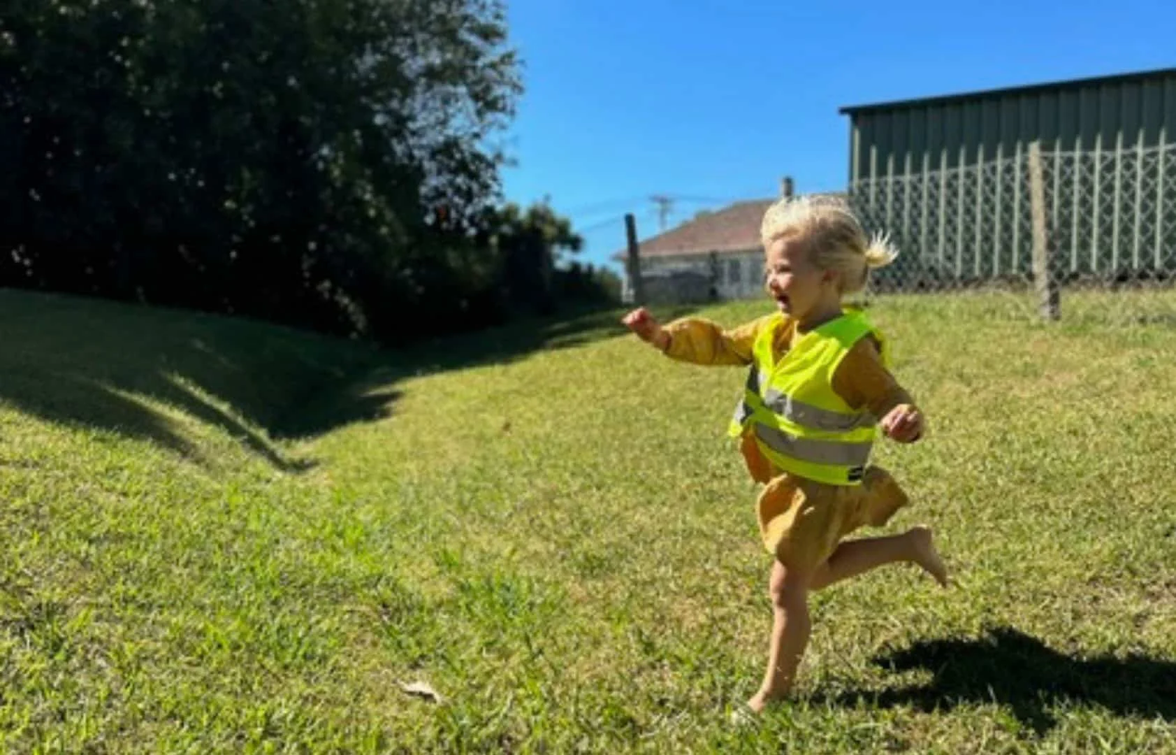 Child running in bright safety vest