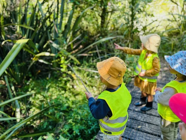 Children exploring nature in hats